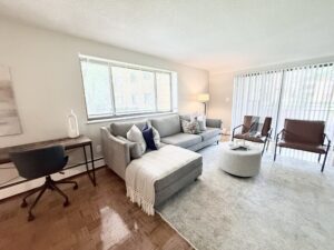 Interior Furnished Unit Living Room, Wood floors, Neutral toned walls, living room adjacent to living room.